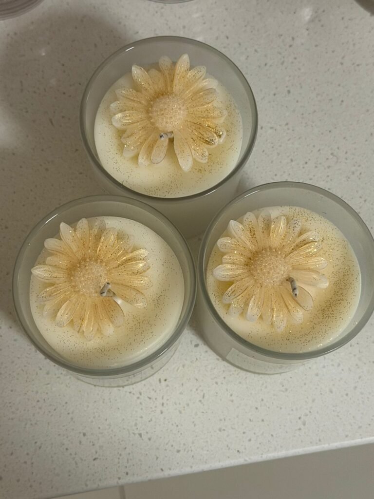 Tres velas artesanales decoradas con flores de cera